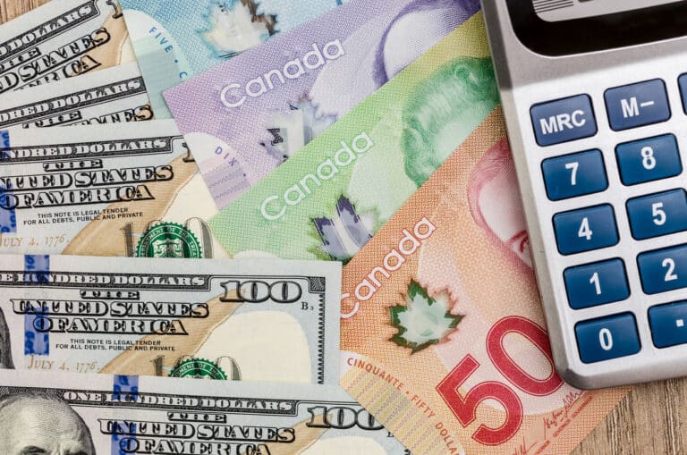 calculator with dollar usd and cad on desk